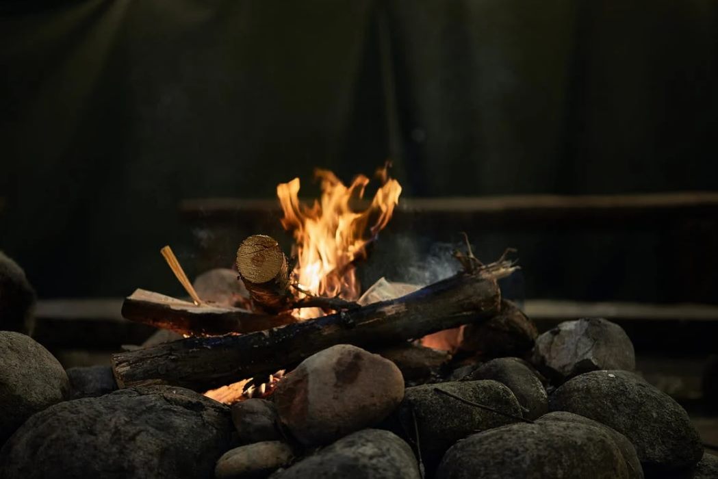 burning wood above rocks · free stock photo goog